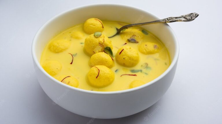 Homemade Rasmalai topped with pistachios and saffron strands