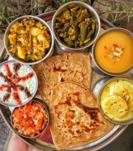 Indian vegetarian thali with dal, roti, rice, and sabzi