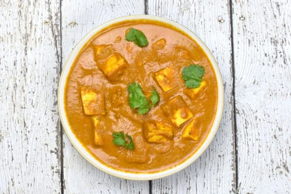 Creamy Paneer Butter Masala garnished with fresh coriander at a family Indian restaurant.