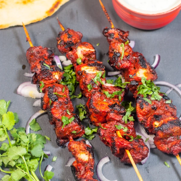Tandoori chicken tikka skewers with onions and fresh coriander served at Punjabi Zaaika Indian restaurant.