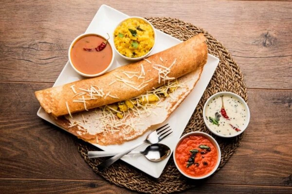 Authentic Masala Dosa served with sambar and coconut chutney at a family Indian restaurant.